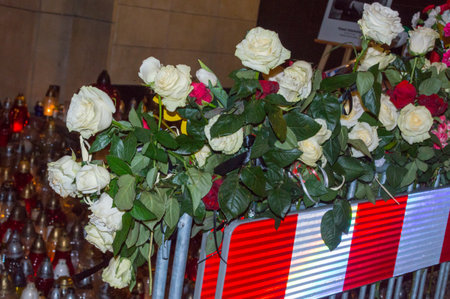 Gdansk, Poland - January 16, 2019:  White and red roses at entrance to city hall of Gdansk at night. Commemoration of Pawel Adamowicz, Mayor of Gdansk, who was stabbed on stage.のeditorial素材
