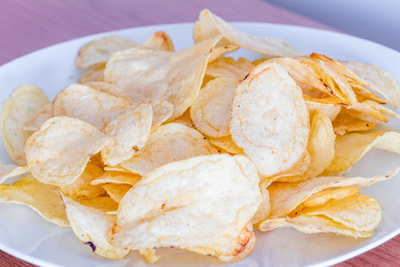 A pile of salted potato chips.の写真素材