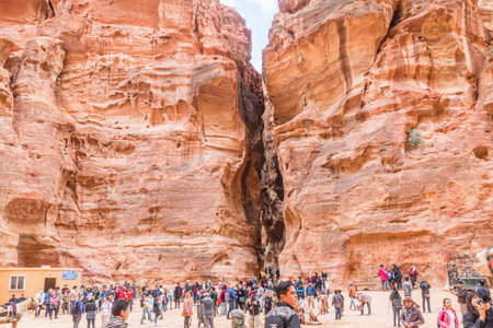 Petra, Jordan - February 8, 2019: Tourist and Siq passage view from Al Khazneh (The Treasury) at Petra, Jordan. Petra is one of the New Seven Wonders of the World.のeditorial素材