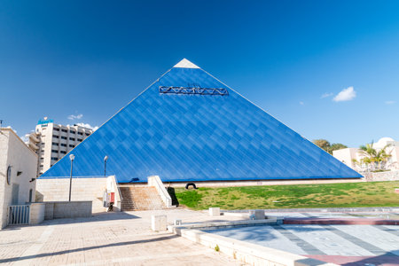 Eilat, Israel - February 9, 2019: The blue pyramid of IMAX cinema in the Gan Binyamin Central Park.のeditorial素材