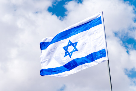 National flag of Israel on a flagpole.の写真素材