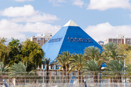 Eilat, Israel - February 9, 2019: The blue pyramid of IMAX cinema and palm trees.のeditorial素材