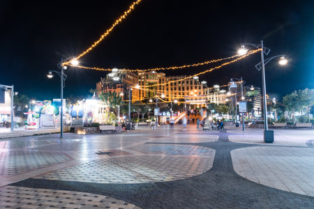 Eilat, Israel - February 9, 2019: Boardwalk at Hananya Beach at night. Eilat is a famous tourist resort and recreational city in Israel.のeditorial素材