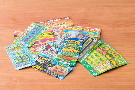 Pruszcz Gdanski, Poland - March 8, 2019: Scratch tickets on wooden table, low cost gambling.のeditorial素材
