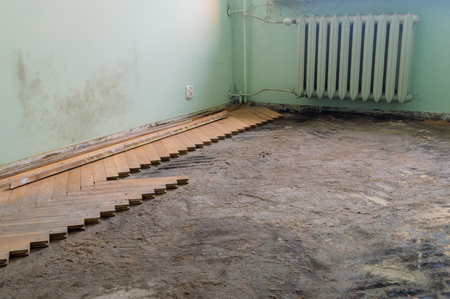 Removing old wooden parquetry on the floor in room.の写真素材