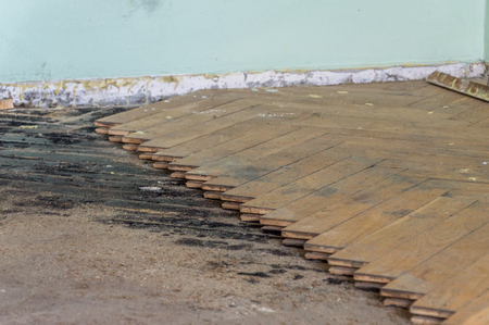 Close-up of removing old wooden parquetry on the floor.の写真素材