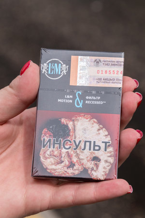 Grodno, Belarus - May 17, 2019: Belarusian L&M pack of cigarettes in woman hand.のeditorial素材