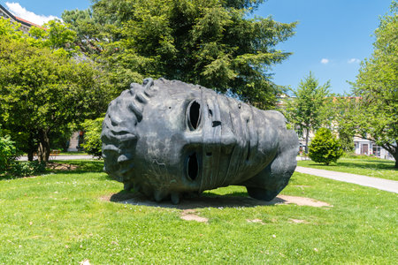 Lugano, Switzerland - June 1, 2019: Head scupulture called Eros Bendato in Civico Park.のeditorial素材