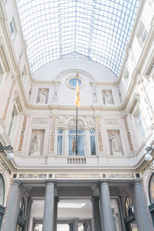 Brussels, Belgium - June 6, 2019: Interior view of the glass ceiling and sculptures inside the Galeries Royales Saint-Hubert.のeditorial素材