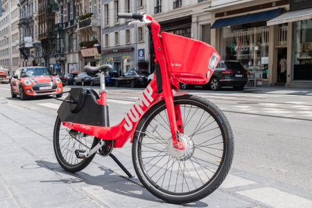 Brussels, Belgium - June 6, 2019: Red Jump Electric bike for rent. JUMP bike operated by Uber on pavement.のeditorial素材