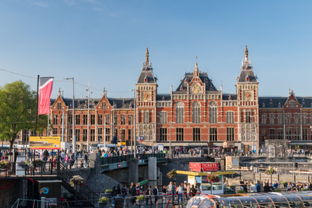 Amsterdam, Netherlands - June 6, 2019: Amsterdam central railway station with many people.のeditorial素材
