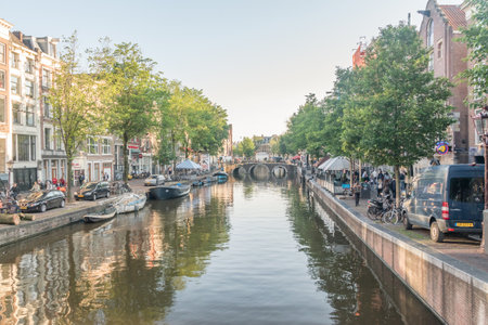 Amsterdam, Netherlands - June 6, 2019: Canal in Amsterdam city center at sunny day.のeditorial素材