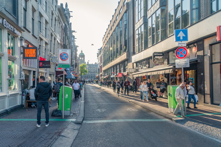 Amsterdam, Netherlands - June 6, 2019: The Damstraat street in Amsterdam, looking west towards Dam square from the bridge over the Oudezijds Voorburgwal canal.のeditorial素材