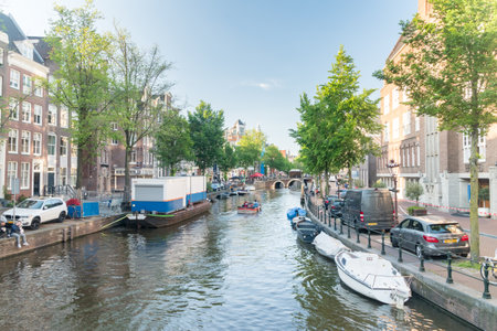 Amsterdam, Netherlands - June 6, 2019: Canal with boats in summer day.のeditorial素材