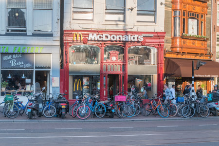 Amsterdam, Netherlands - June 6, 2019: View of McDonald's in retro building on the Muntplein street.のeditorial素材