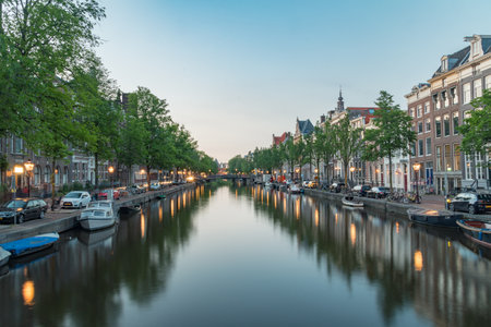 Amsterdam, Netherlands - June 6, 2019: View of Kloveniersburgwal canal in the evening.のeditorial素材