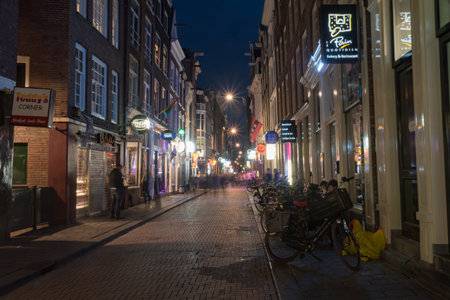 Amsterdam, Netherlands-June 6, 2019: Warmoesstraat street at historic center of the city in the night.のeditorial素材
