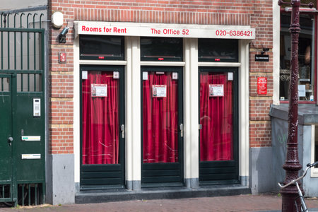 Amsterdam, Netherlands - June 7, 2019: View of the prostitution windows in red light district in Amsterdam.のeditorial素材