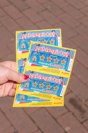 Hanover, Germany - June 8, 2019: Lotto zahlenzirkus lottery scratch card in woman hand.のeditorial素材