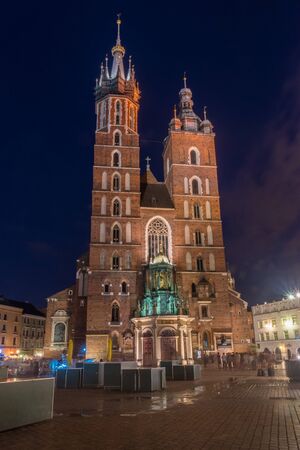 St. Mary's Church on market square at night in Krakow, Poland.の写真素材