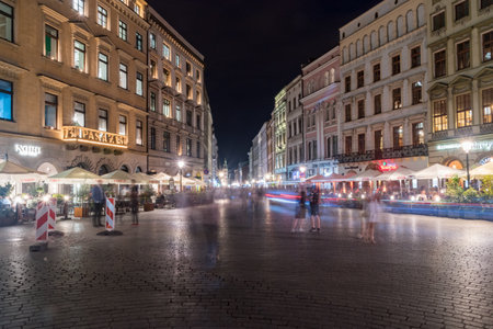 Krakow, Poland - July 26, 2019: Long exposure picture of Grodzka street with blurred people at night.のeditorial素材