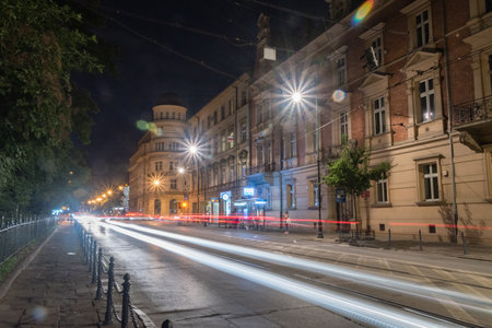 Krakow, Poland - July 26, 2019: Night Gertrude the Great street view with car light trails.のeditorial素材