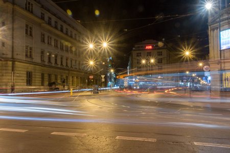 Krakow, Poland - July 26, 2019: Street intersection in the center of Krakow with car light trails at night.のeditorial素材