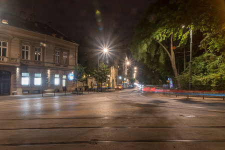 Krakow, Poland - July 26, 2019: Night street view with car light trails.のeditorial素材
