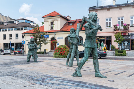 Wieliczka, Poland - July 27, 2019: Sculptures of medieval salt mine workers at the main market square.のeditorial素材