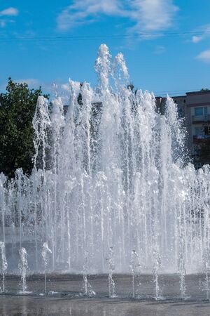 Splashes of fountain water at sunny day.の写真素材