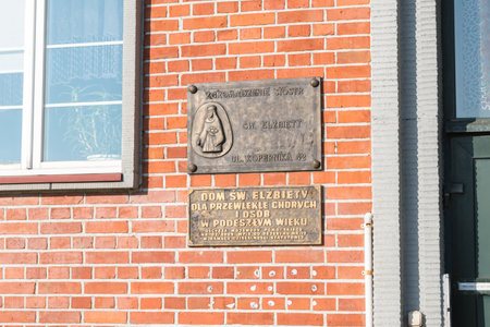 Kwidzyn, Poland - September 22, 2019: Plaque with information about home of St. Elizabeth for chronically ill and elderly people.のeditorial素材