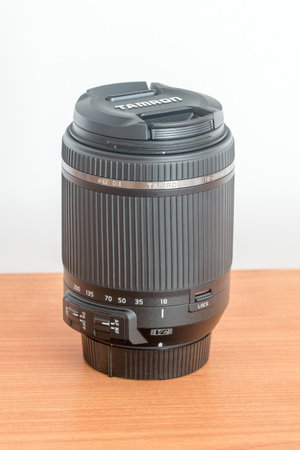 Pruszcz Gdanski, Poland - October 9, 2019: Tamron 18-200 mm f/3.5-6.3 Di II VC lens on wooden table.のeditorial素材