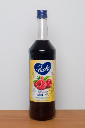 Pruszcz Gdanski, Poland - January 12, 2020: Paola raspberry juice in a glass bottle on wooden table.のeditorial素材