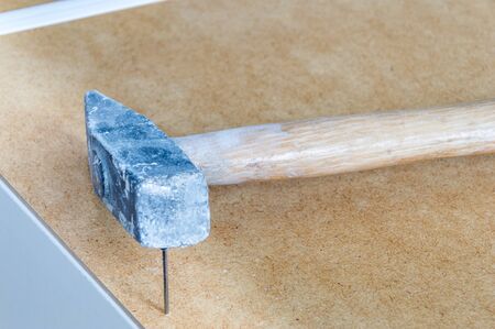 Nails embedded in the furniture with hammer.の写真素材