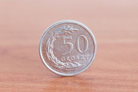 Polish 50 groszy coin on wooden table.の写真素材