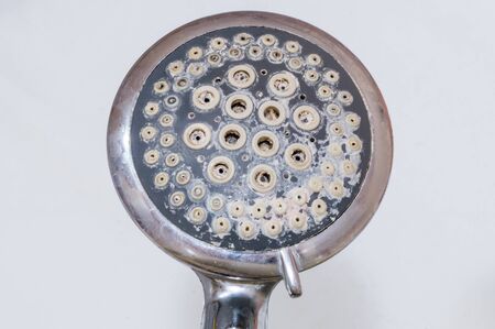 Close-up of limescale on shower head. Calcification of a shower head in bathroom.の写真素材