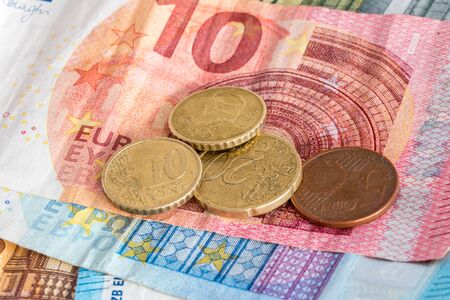 Euro cent coins on euro banknotes.の写真素材