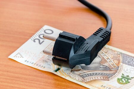Black power plug on Polish 200 banknote.の写真素材