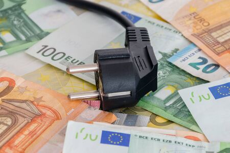 Black power plug on euro banknotes.の写真素材