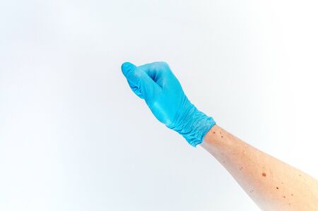 Fist hand in medical glove on white background.の写真素材