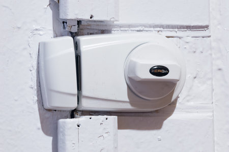 Deblin, Poland - April 20, 2020: White Gerda rim lock on door.のeditorial素材