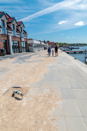 Mikolajki, Poland - June 1, 2020: Pavement with touris along marina on Mikolajskie lake.のeditorial素材