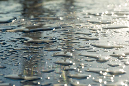 Water drop on car roof in the sun.の写真素材