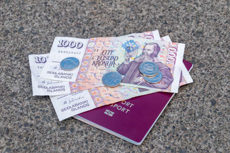 Passport with Icelandic krona banknotes and coins.の写真素材