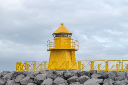 Yellow Hofdi lighthouse in Reykjavik, Iceland.の写真素材