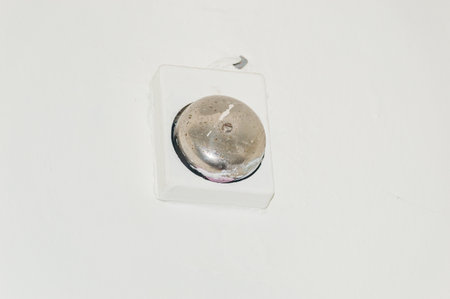 Old electric metal bell on the wall.