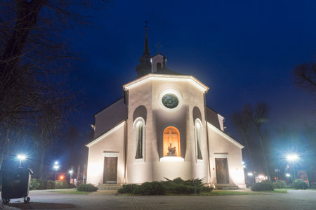 Kozienice, Poland - December 24, 2020: Church of the Holy Cross parish at night.のeditorial素材
