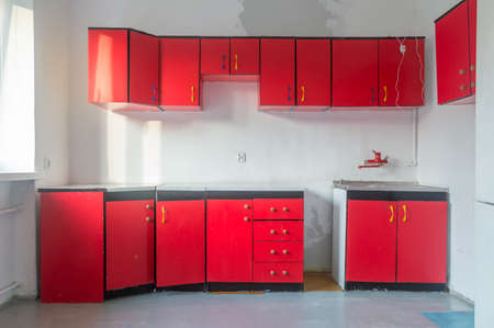 Old kitchen with red kitchen cabinets.の写真素材