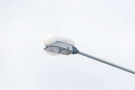 Street lamp covered with snow.