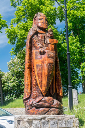 Bytow, Poland - May 31, 2021: Wooden sculpture next to Bytow castle of gothic Teutonic castle and a former stronghold for Pomeranian dukes.のeditorial素材